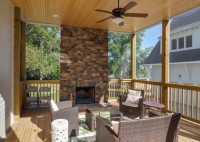 A-porch-with-a-fireplace-and-comfy-wicker-furniture