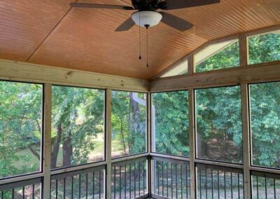 a-sunroom-with-a-ceiling-fan-and-a-wooden-deck