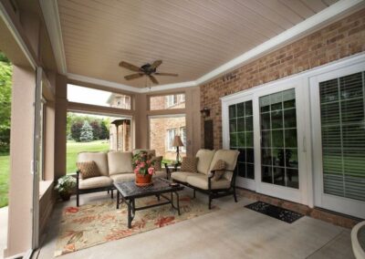 Relaxing-sunroom-with-outdoor-seating-and-fan